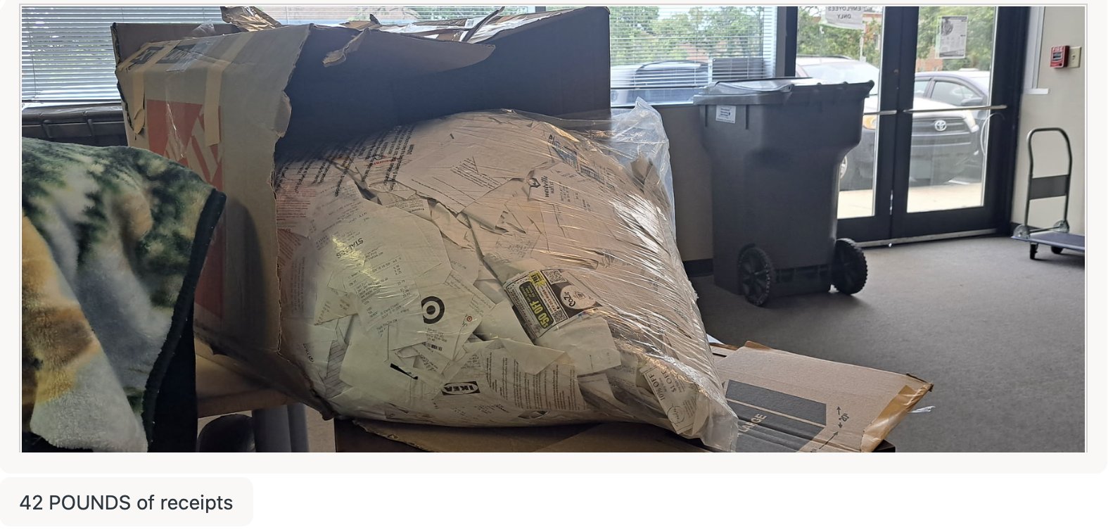 A 42-pound shipment of paper receipts a customer mailed to Shoeboxed for scanning, sitting on a desk in our office